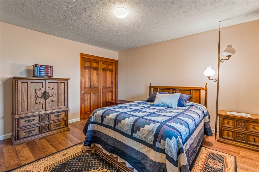 610 West Alex Bell Road Dayton, OH 45459 - Photo 25 of 36 This cozy bedroom features warm wood tones and ample natural light, perfect for peaceful slumber.