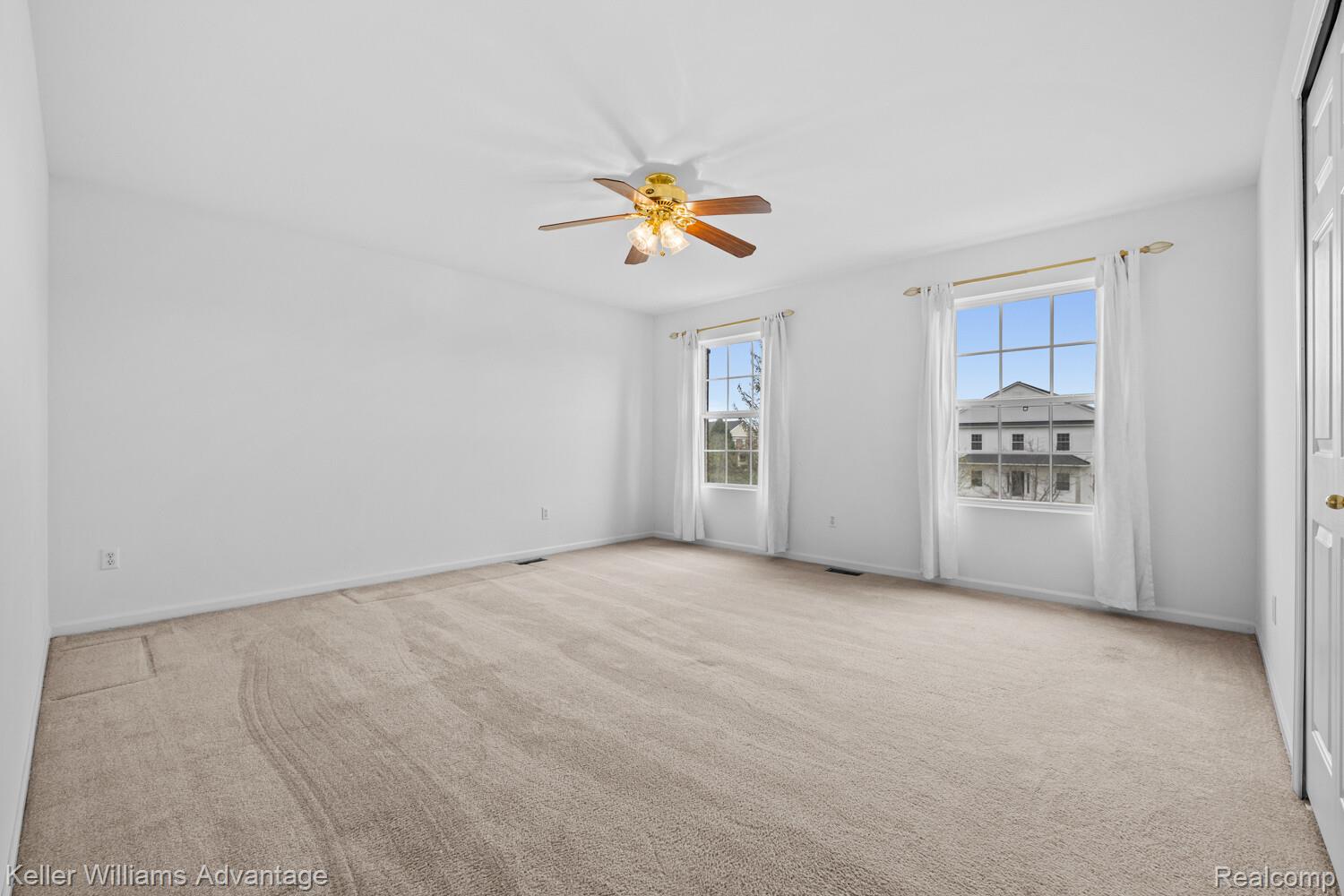 4100 Norwich Court Rochester, MI 48306 - Photo 40 of 72 Spare room with healthy amount of natural light, ceiling fan, and light colored carpet