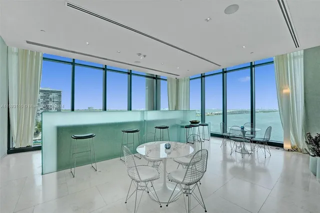 a balcony with furniture and a floor to ceiling window