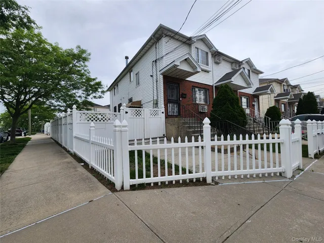 a front view of a house with wooden fence