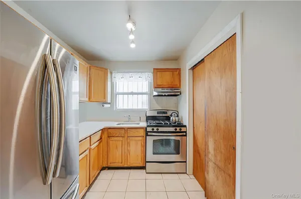 a kitchen with a sink cabinets and stainless steel appliances