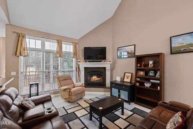 a living room with a fireplace and a flat screen tv