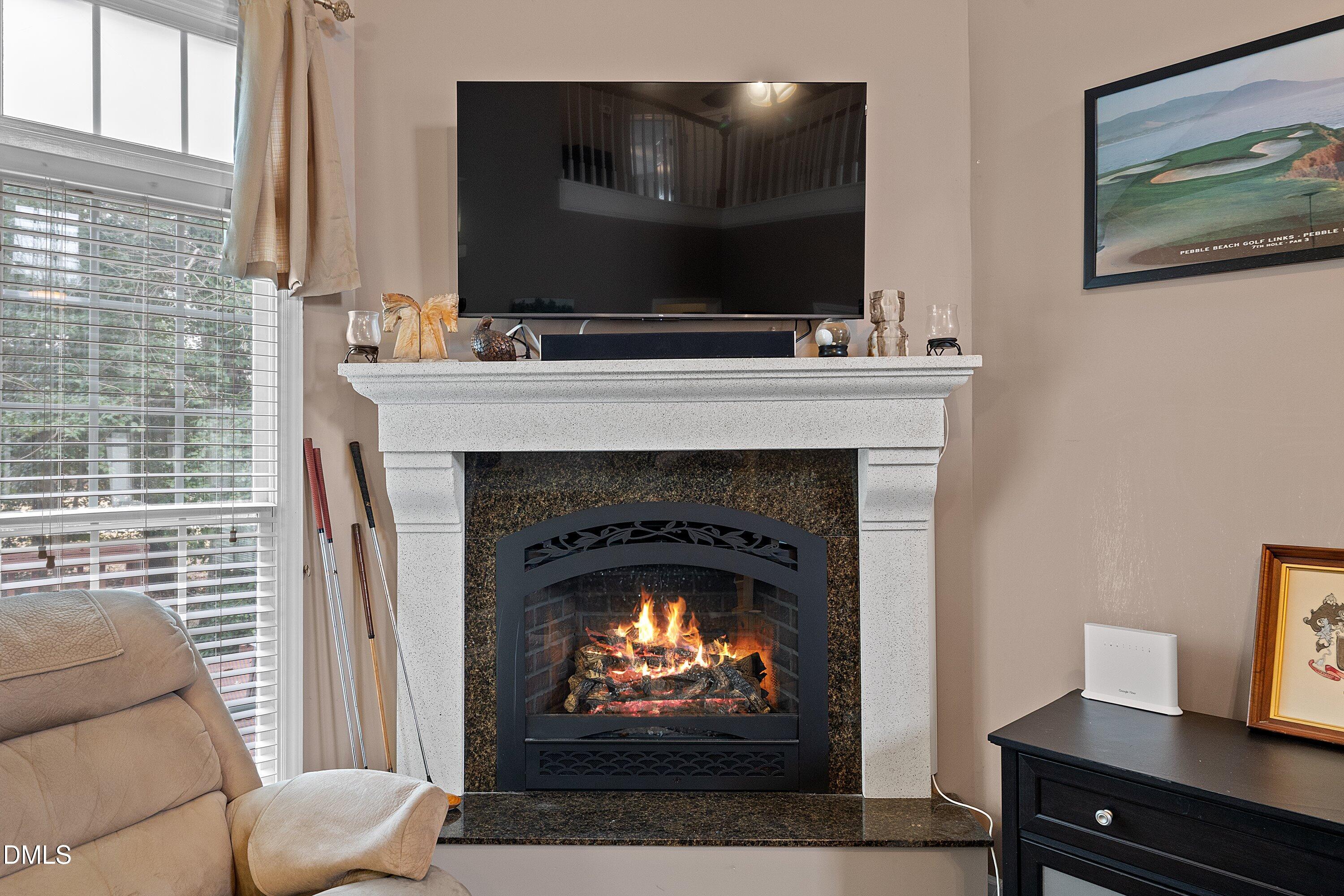 1916 Spanish Bay Court Raleigh, NC 27604 - Photo 13 of 63 a living room with a fireplace and a flat screen tv