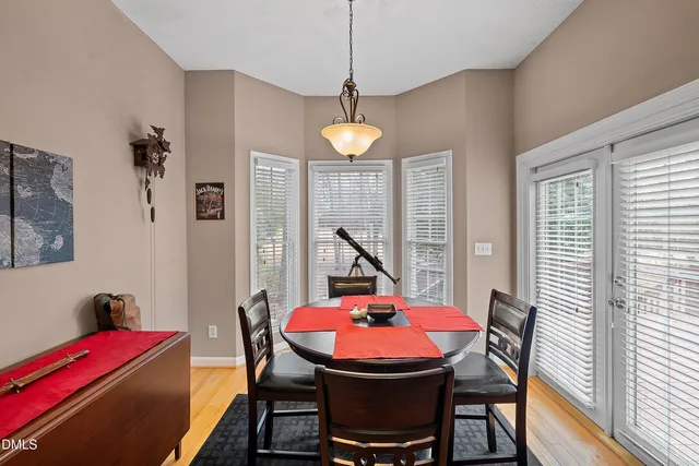a view of a dining room with furniture and a chandelier