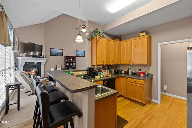 a kitchen with kitchen island granite countertop a sink counter top space and cabinets