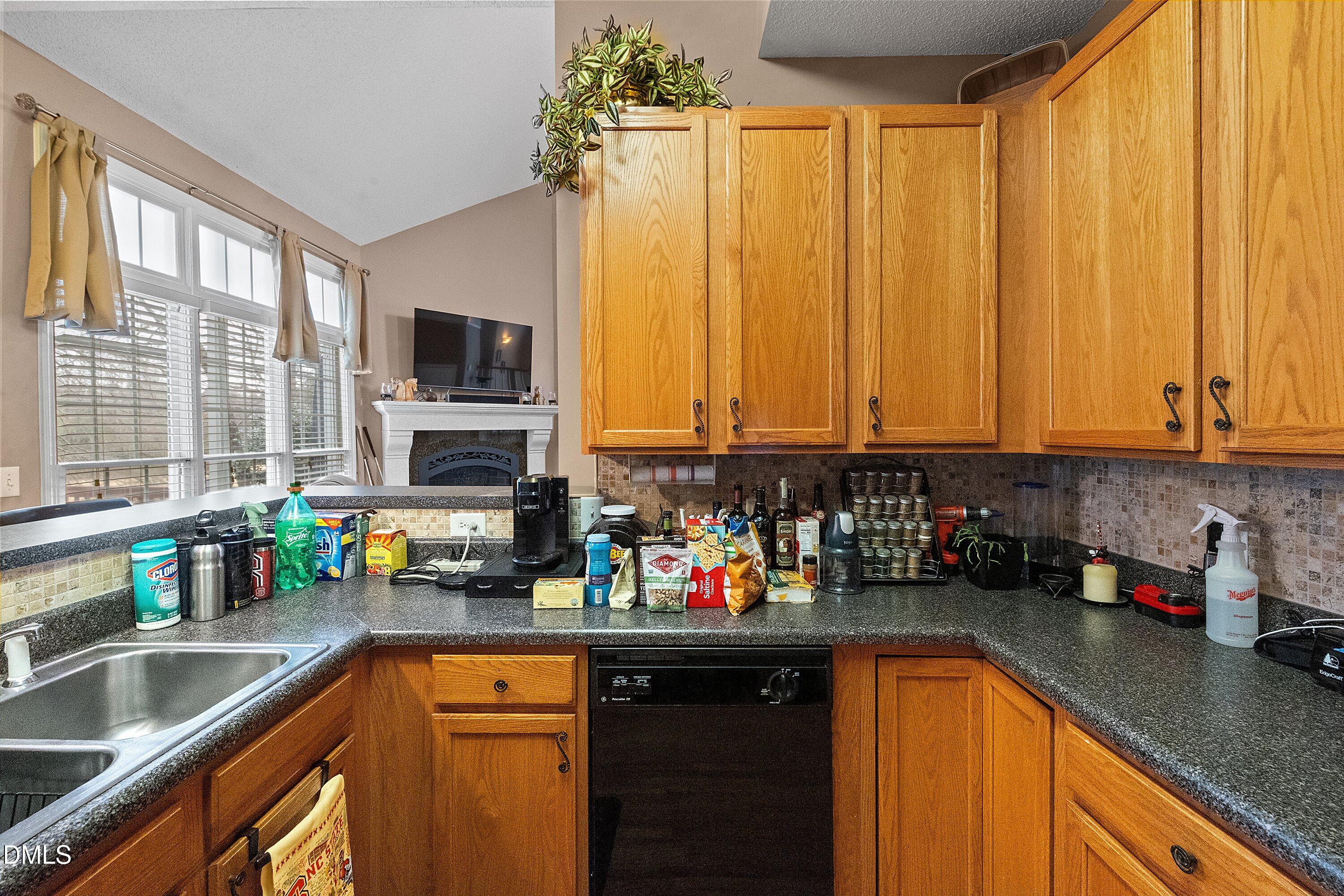 1916 Spanish Bay Court Raleigh, NC 27604 - Photo 19 of 63 a kitchen with kitchen island granite countertop a sink counter top space and cabinets