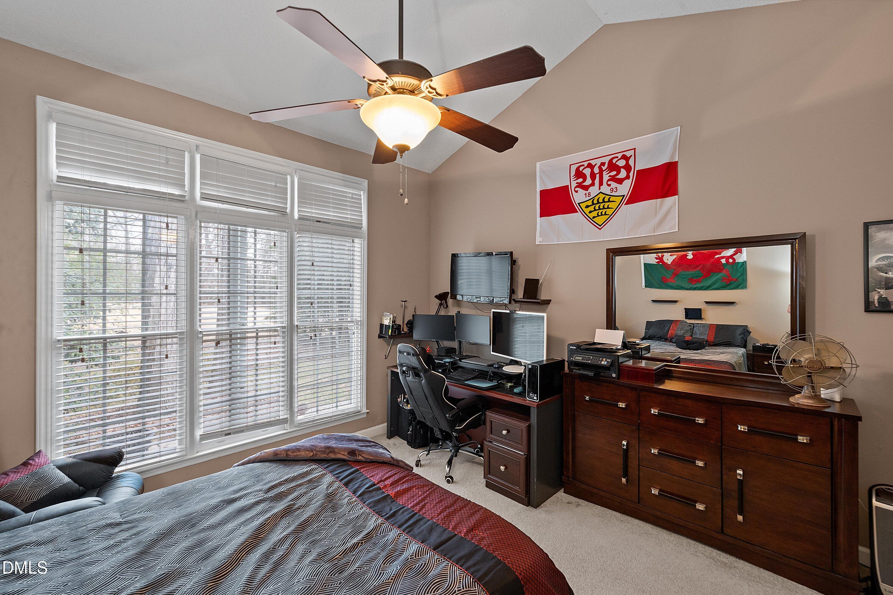 1916 Spanish Bay Court Raleigh, NC 27604 - Photo 21 of 63 a bedroom with a bed and a flat screen tv