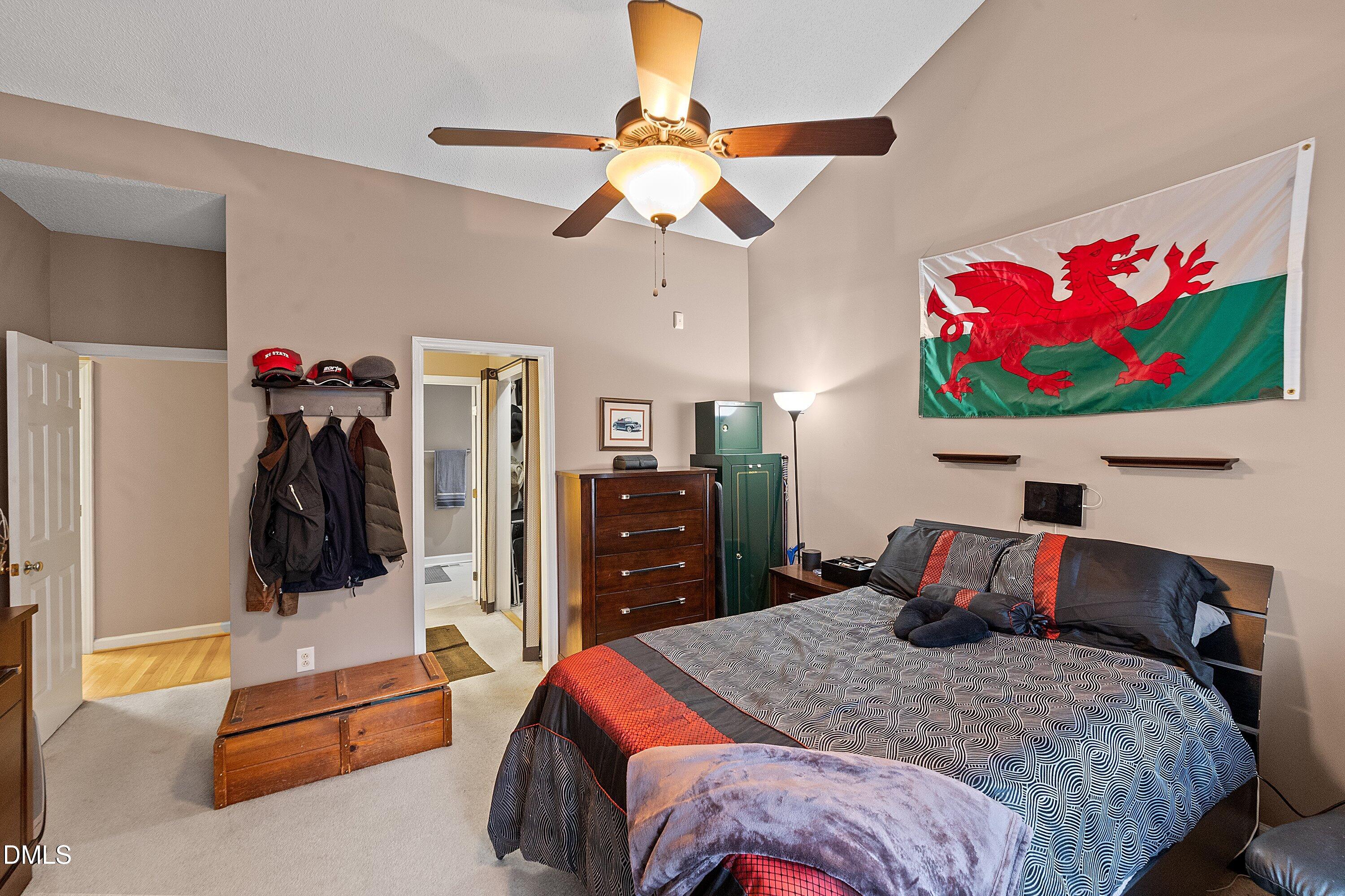 1916 Spanish Bay Court Raleigh, NC 27604 - Photo 22 of 63 a bedroom with a bed and a chandelier