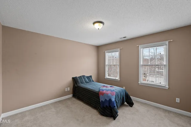 a bedroom with a bed and a chair