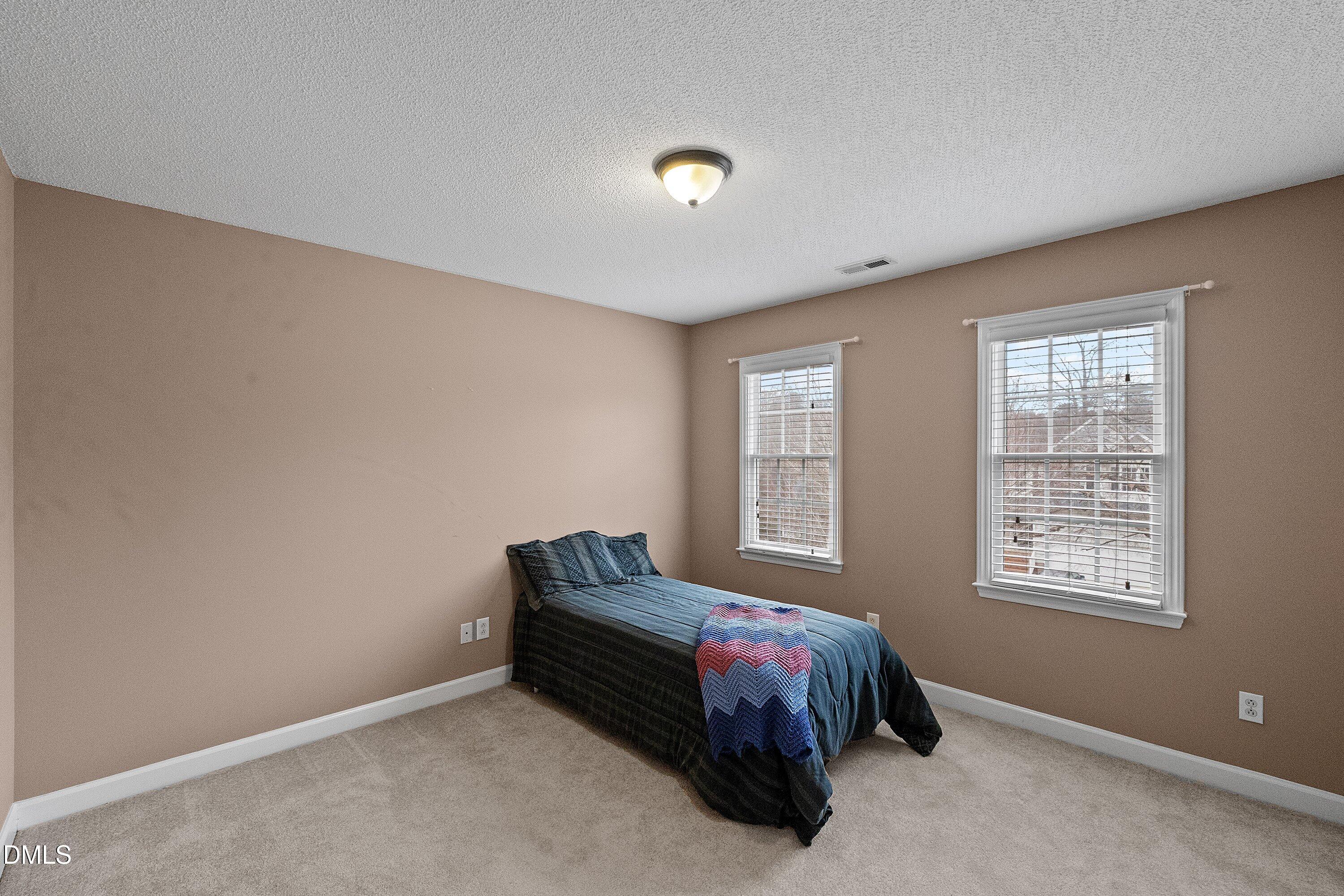 1916 Spanish Bay Court Raleigh, NC 27604 - Photo 28 of 63 a bed room with a bed and a window