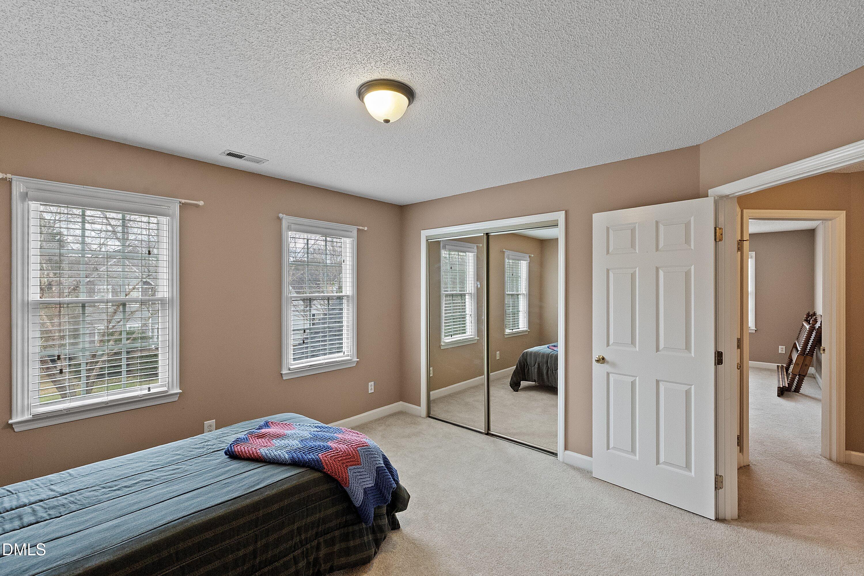 1916 Spanish Bay Court Raleigh, NC 27604 - Photo 29 of 63 a bedroom with a bed and a window