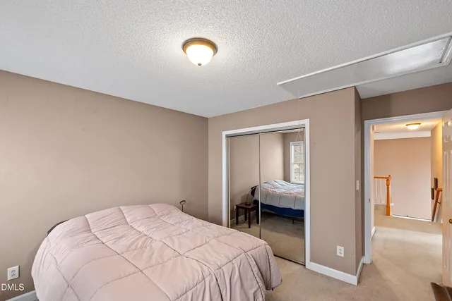 a bed room with a window and a ceiling fan