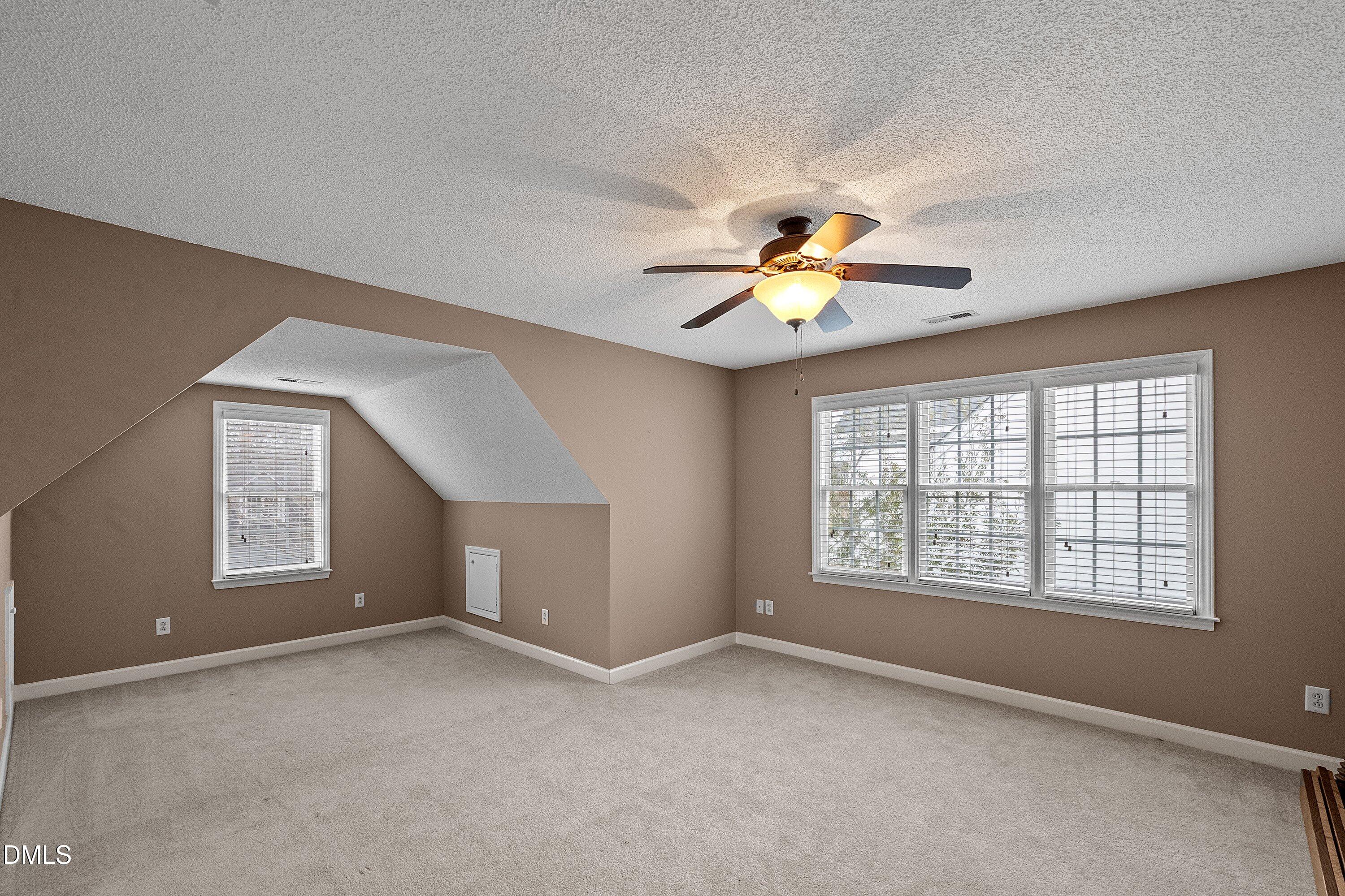1916 Spanish Bay Court Raleigh, NC 27604 - Photo 32 of 63 an empty room with chandelier fan and windows