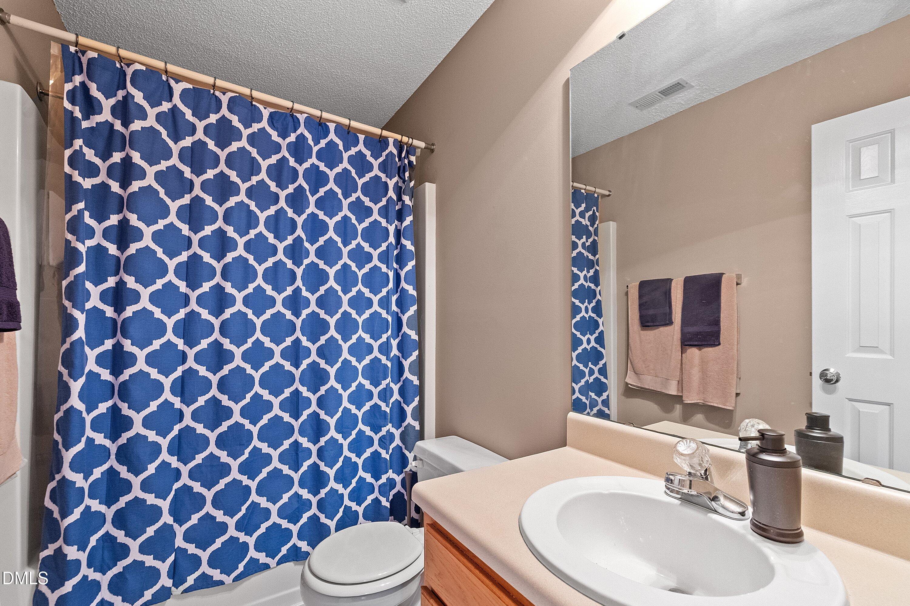 1916 Spanish Bay Court Raleigh, NC 27604 - Photo 36 of 63 a bathroom with a sink and a mirror