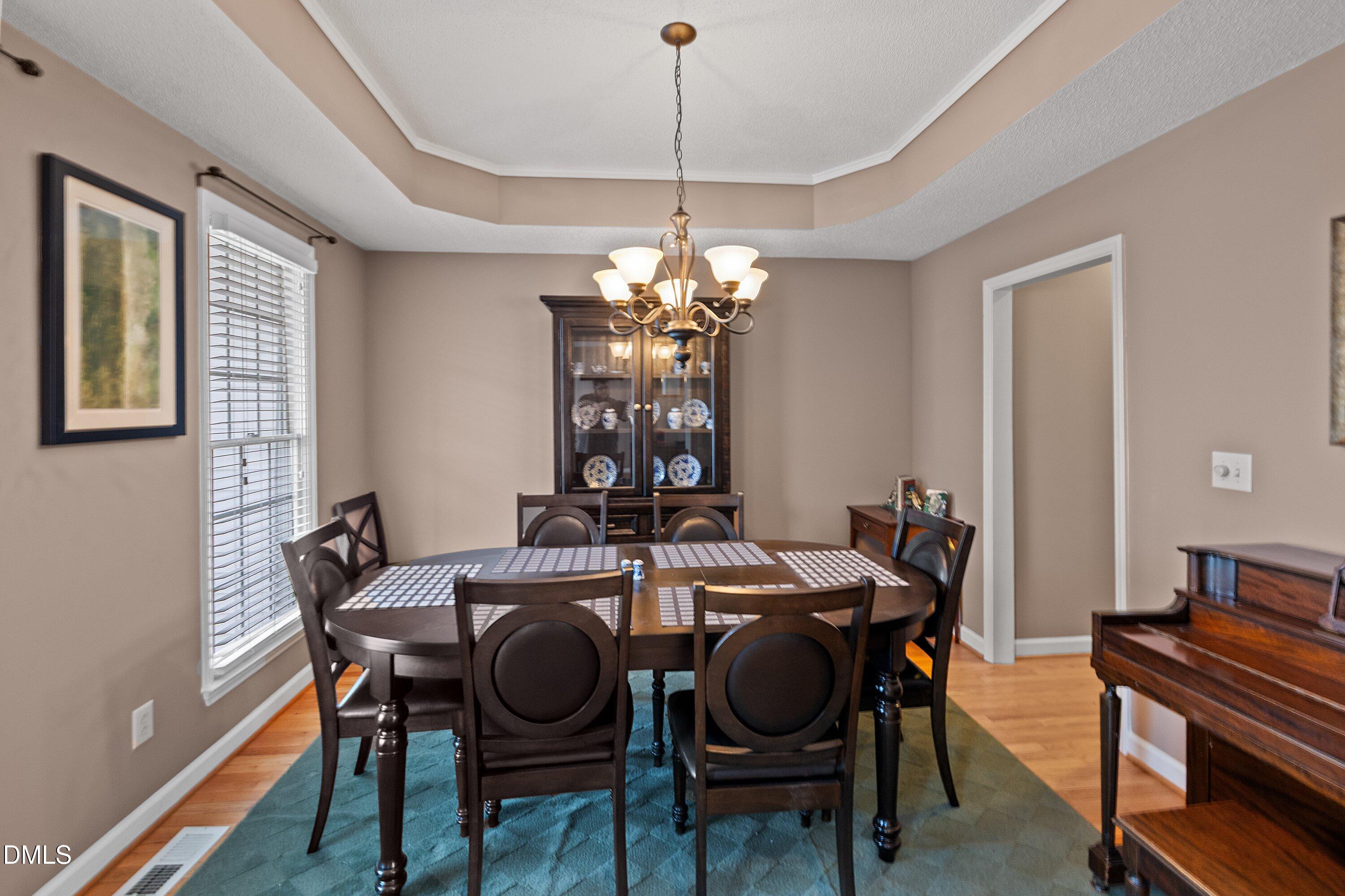 1916 Spanish Bay Court Raleigh, NC 27604 - Photo 8 of 63 a view of a dining room with furniture and chandelier