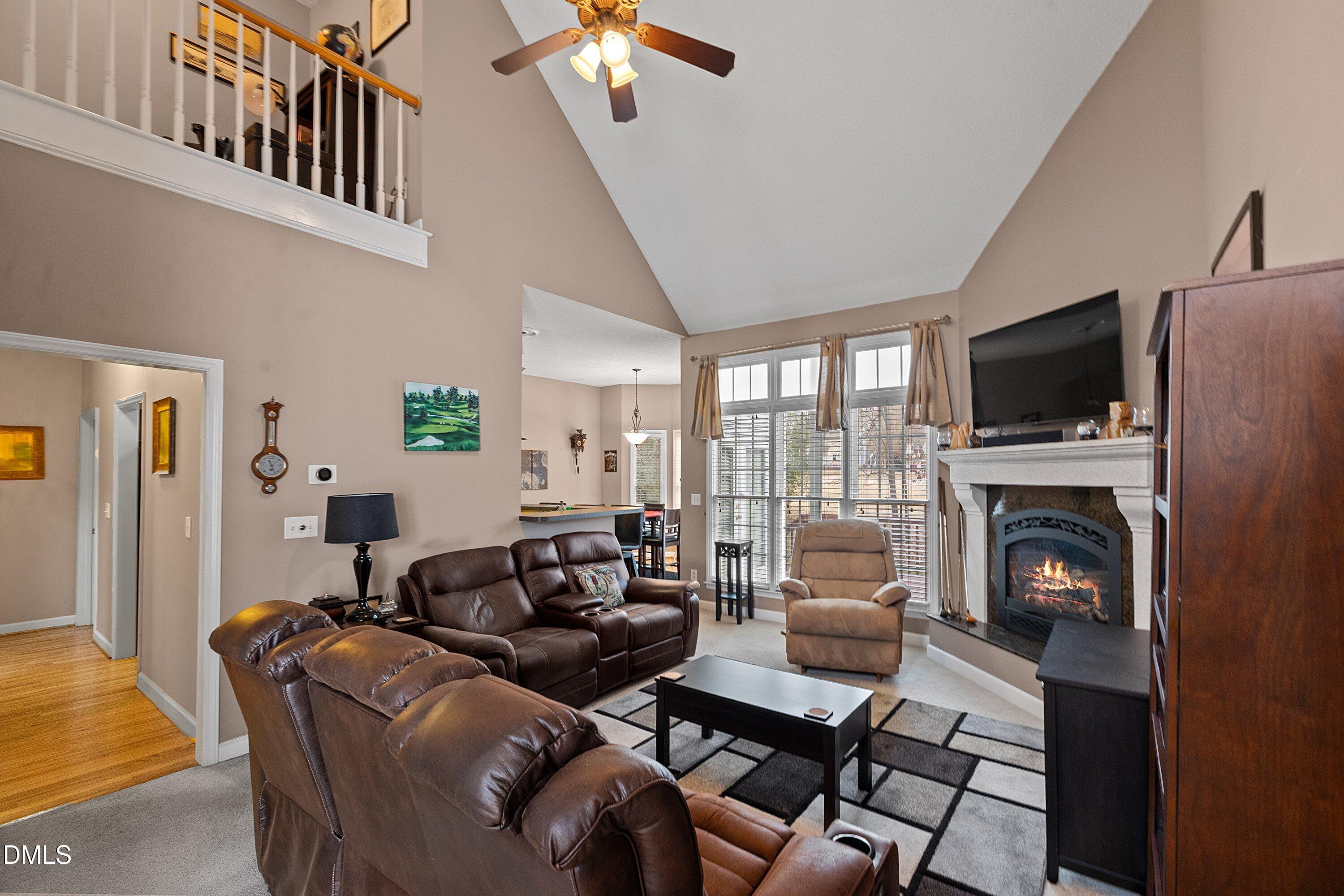 1916 Spanish Bay Court Raleigh, NC 27604 - Photo 10 of 63 a living room with furniture a fireplace and a flat screen tv