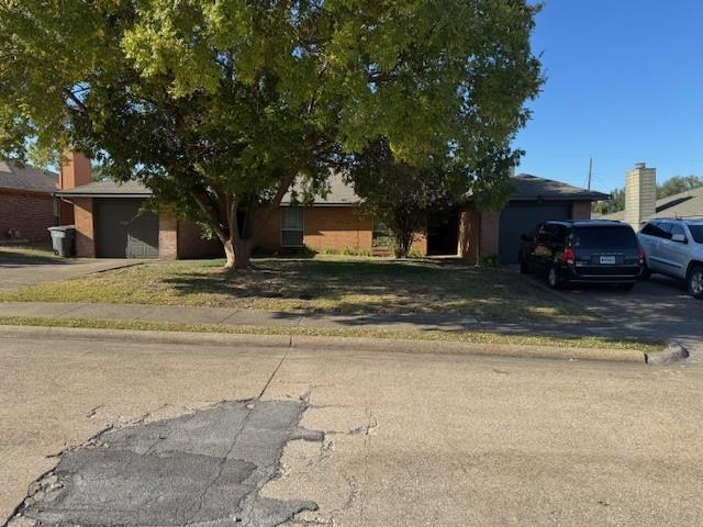 4023 William Street Sachse, TX 75048 - Photo 1 of 36 Obstructed view of property featuring brick siding, a garage, and driveway