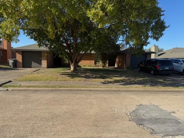 4023 William Street Sachse, TX 75048 - Photo 24 of 36 View of front facade with brick siding, a garage, and driveway