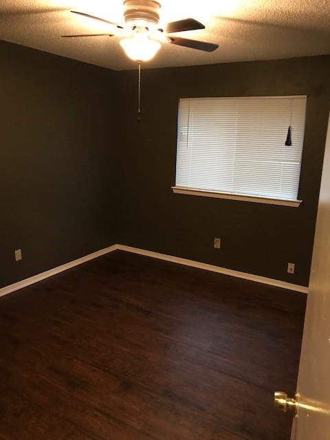 4023 William Street Sachse, TX 75048 - Photo 29 of 36 Empty room featuring a textured ceiling, dark wood finished floors, and ceiling fan