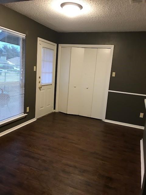 4023 William Street Sachse, TX 75048 - Photo 35 of 36 Foyer with a textured ceiling and dark wood-style flooring