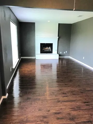 a view of a living room with wooden floor