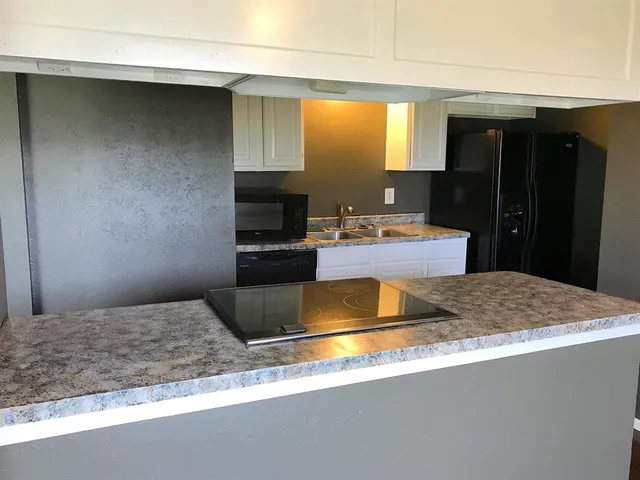 a kitchen with a appliances and a sink