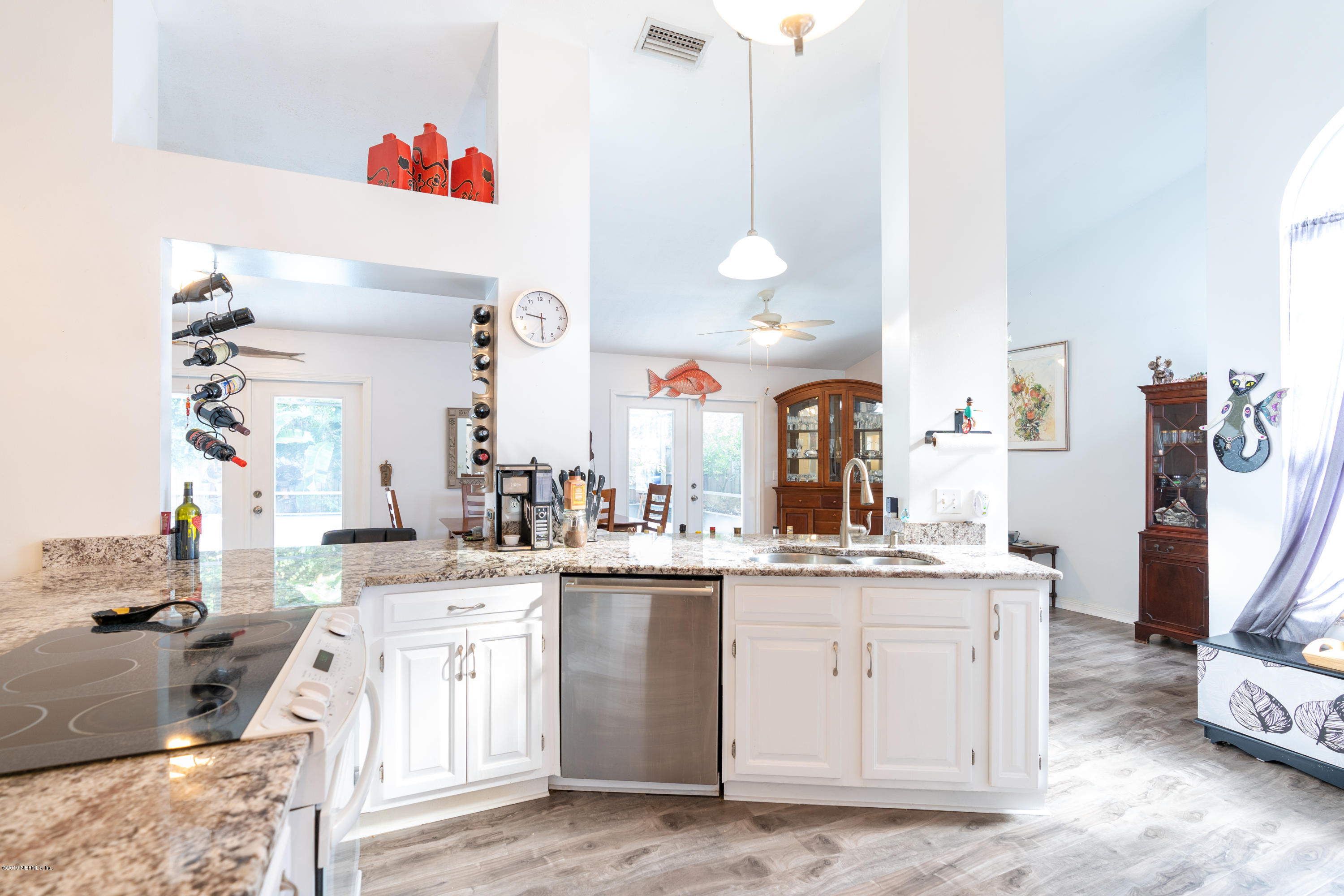 9 Beach Street St. Augustine, FL 32080 - Photo 11 of 28 a kitchen with a sink stove and cabinets