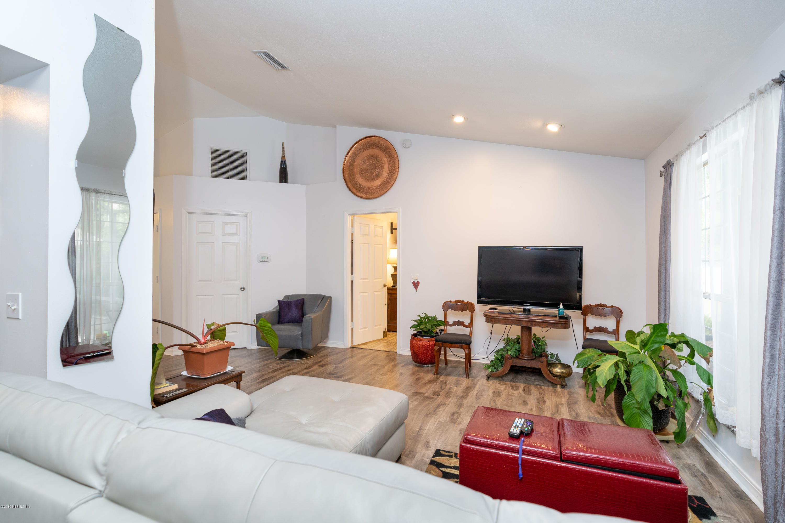 9 Beach Street St. Augustine, FL 32080 - Photo 13 of 28 a living room with furniture and a flat screen tv