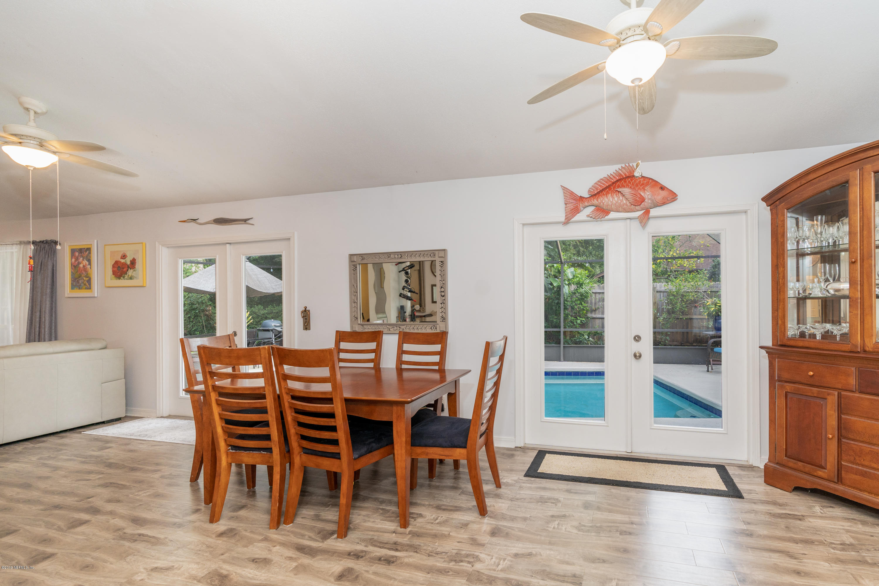 9 Beach Street St. Augustine, FL 32080 - Photo 15 of 28 a dining room with furniture a chandelier and wooden floor