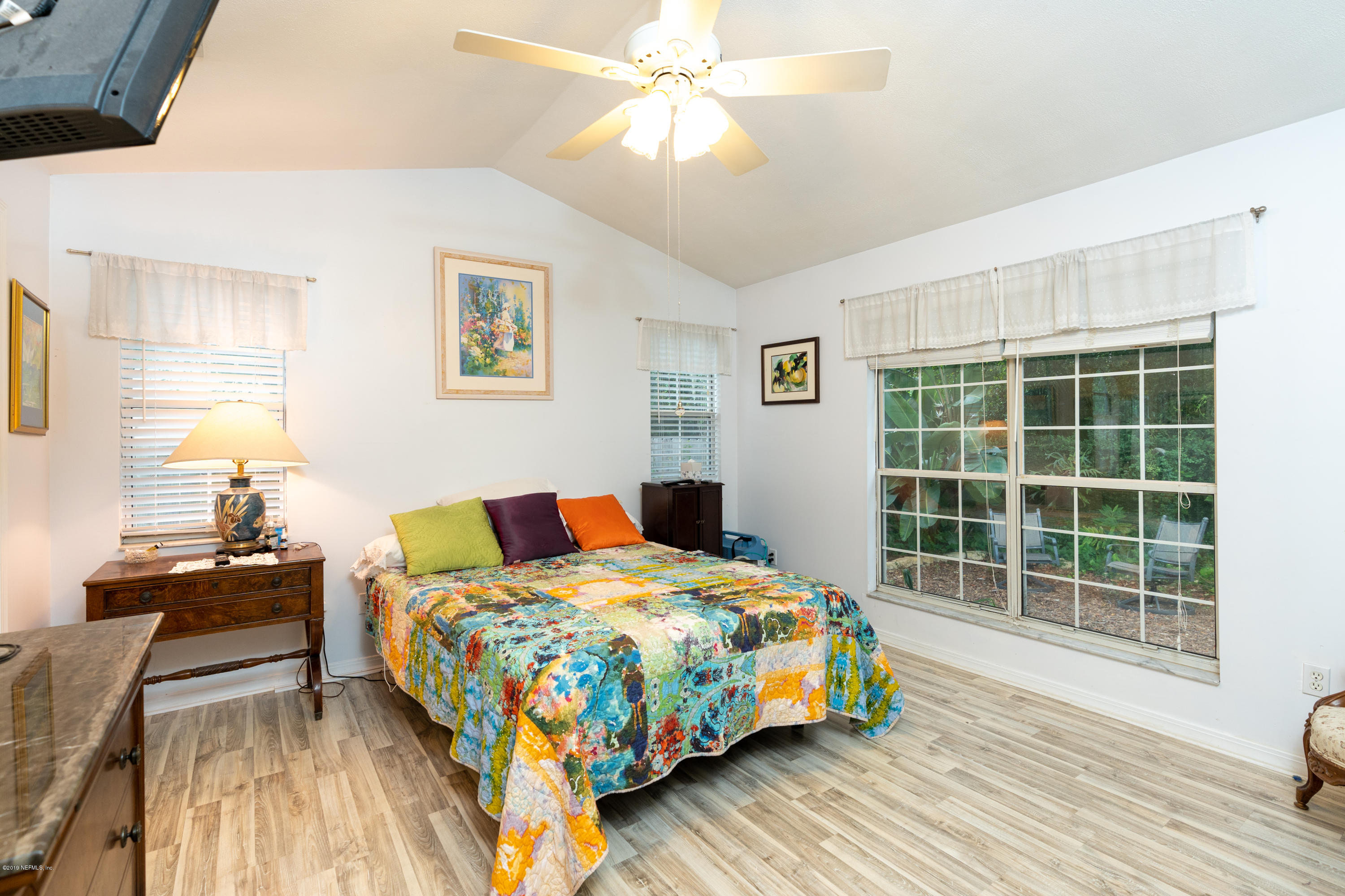 9 Beach Street St. Augustine, FL 32080 - Photo 20 of 28 a bedroom with a bed and wooden floor