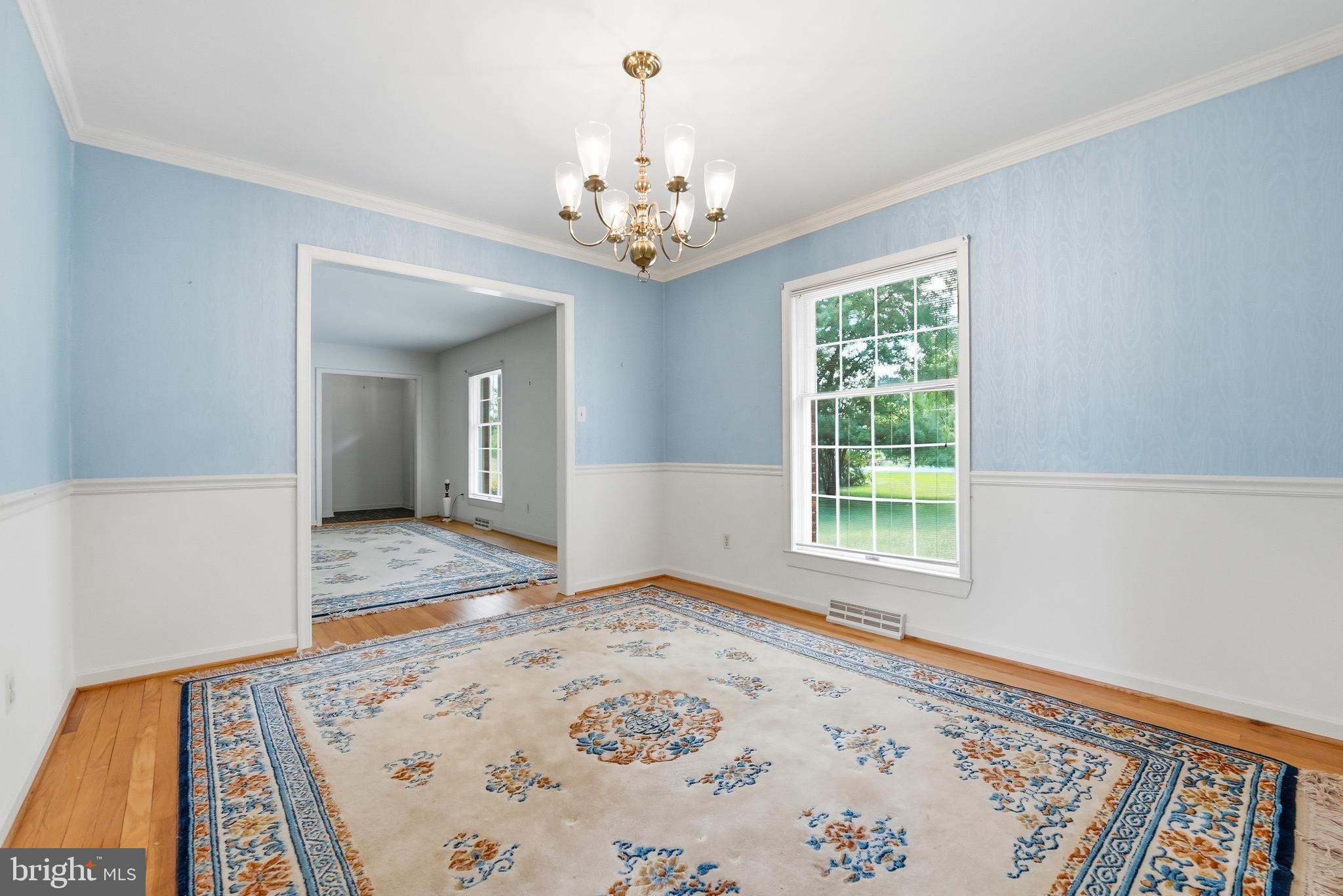 11081 Marquis Road Unionville, VA 22567 - Photo 18 of 49 a view of a bedroom with wooden floor and a chandelier