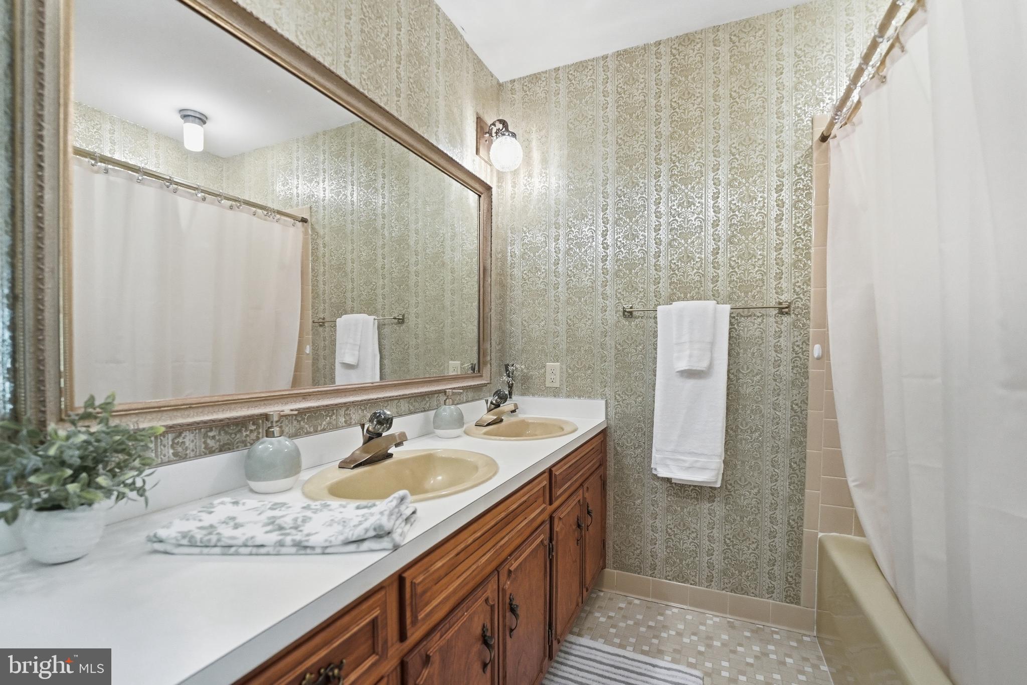 11081 Marquis Road Unionville, VA 22567 - Photo 32 of 49 a bathroom with a granite countertop sink and a mirror