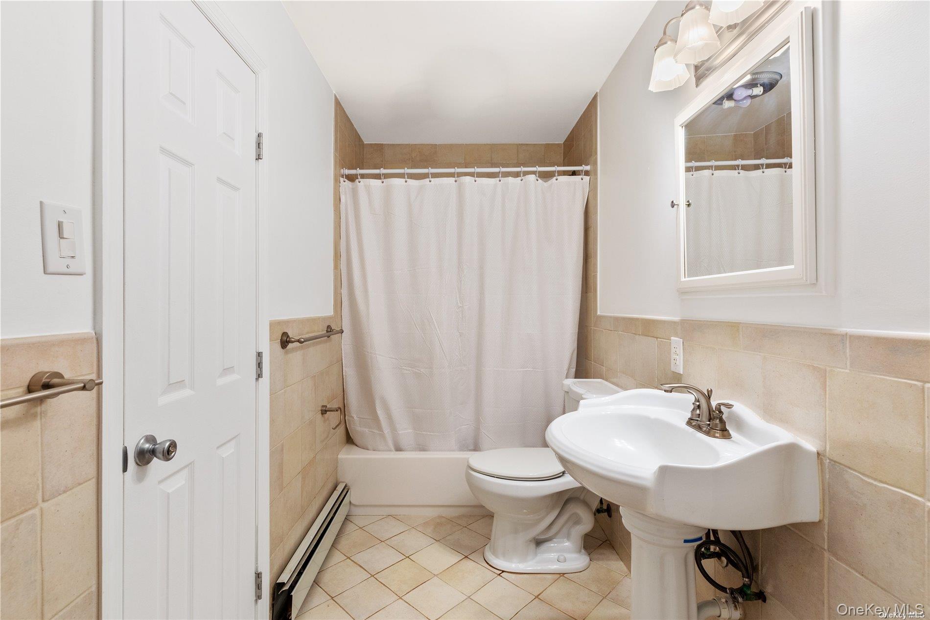 110 East Bartlett Road Middle Island, NY 11953 - Photo 15 of 29 a bathroom with a sink toilet and a mirror