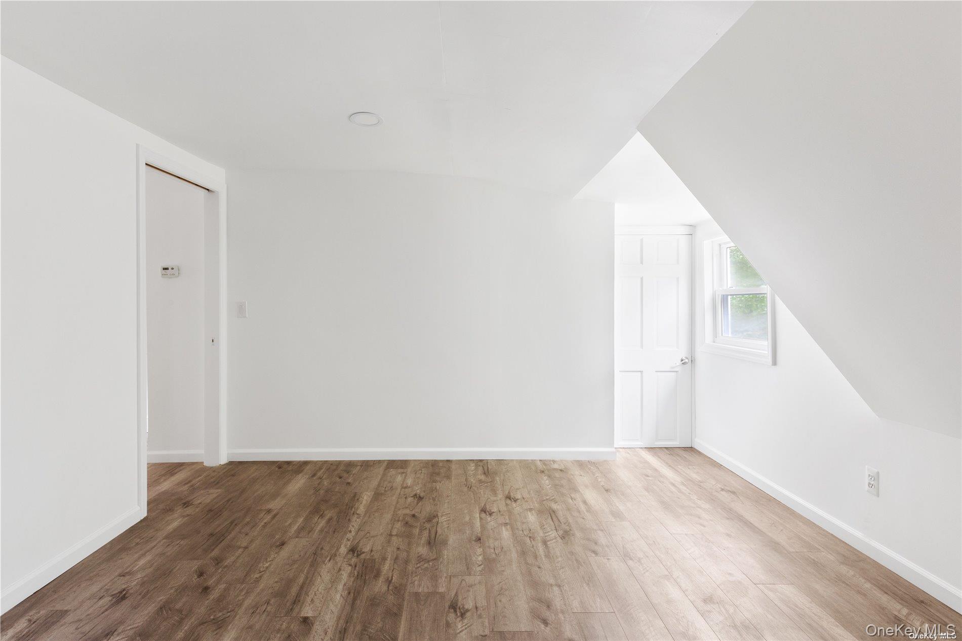 110 East Bartlett Road Middle Island, NY 11953 - Photo 18 of 29 an empty room with wooden floor and windows