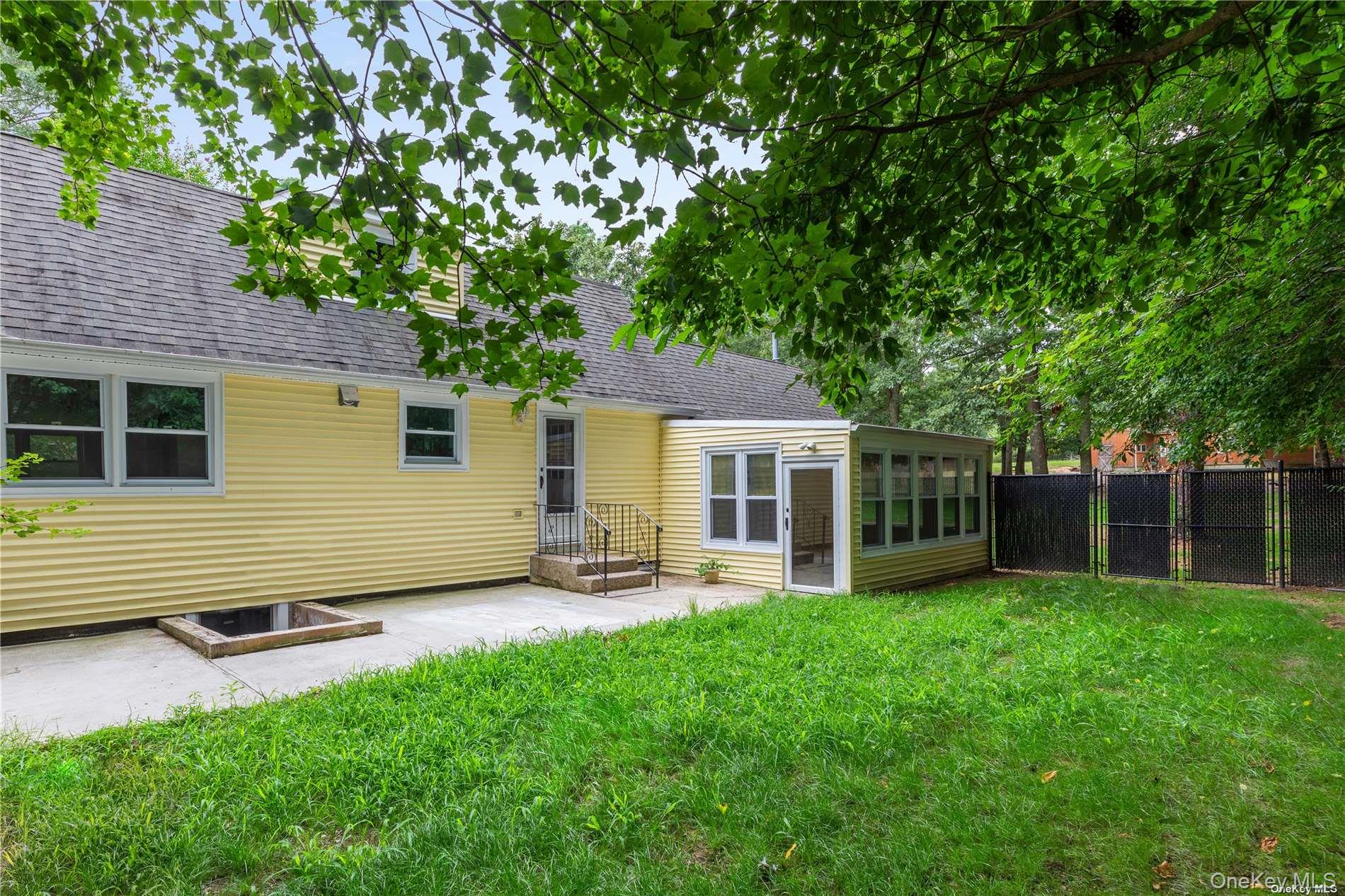 110 East Bartlett Road Middle Island, NY 11953 - Photo 27 of 29 a view of a house with a yard and sitting area