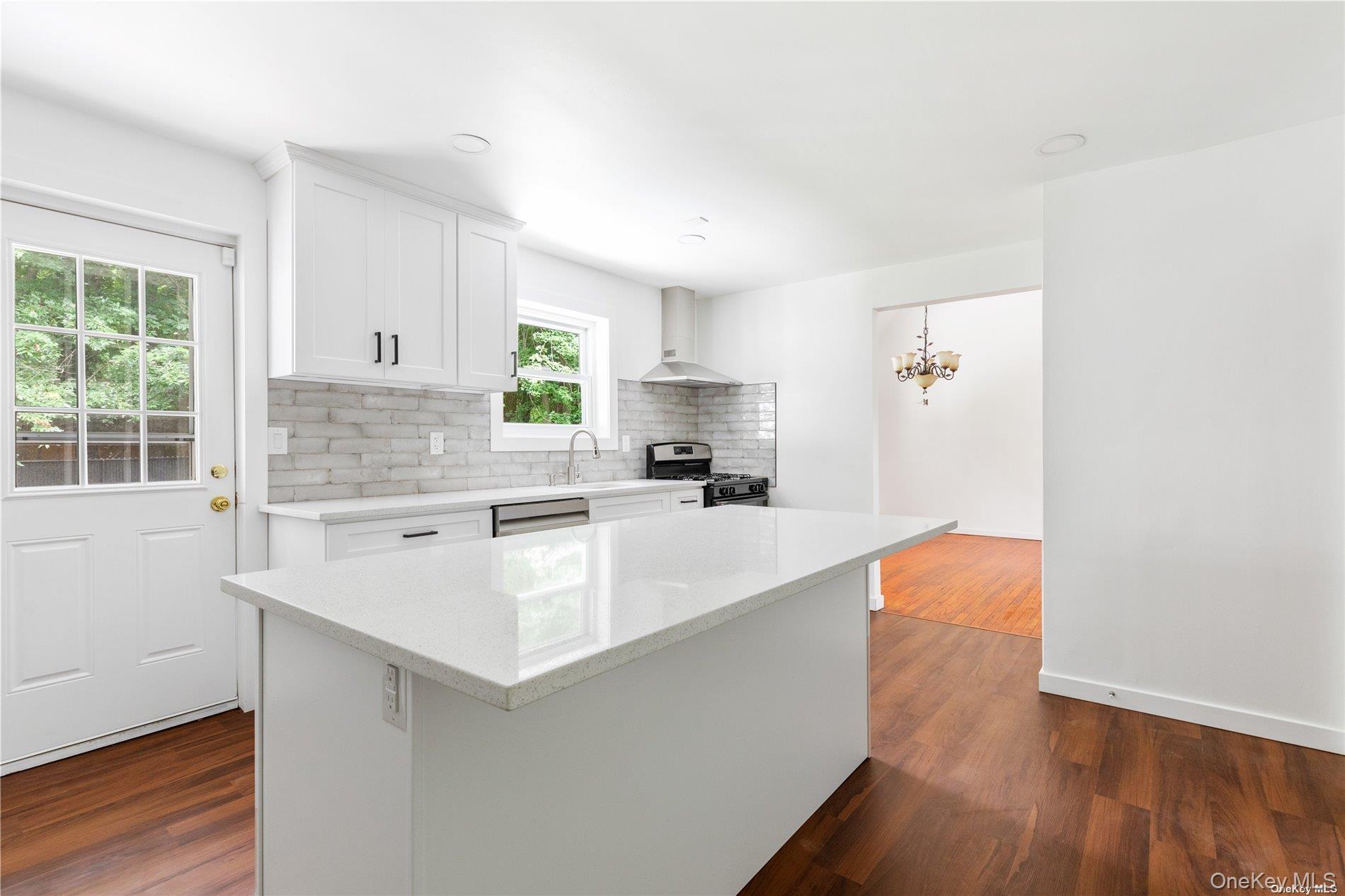 110 East Bartlett Road Middle Island, NY 11953 - Photo 10 of 29 a large kitchen with granite countertop a sink and a stove top oven