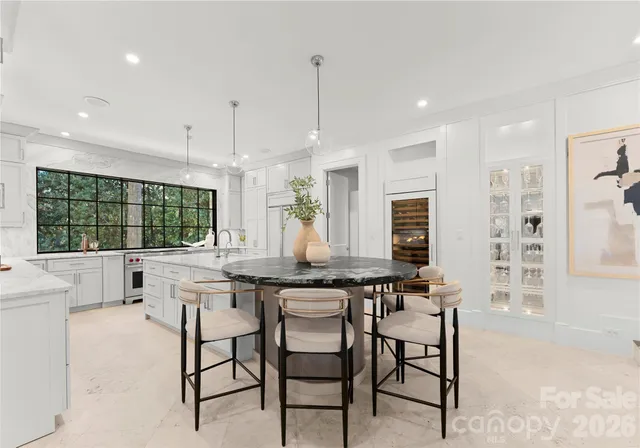 a dining room with furniture a chandelier and window