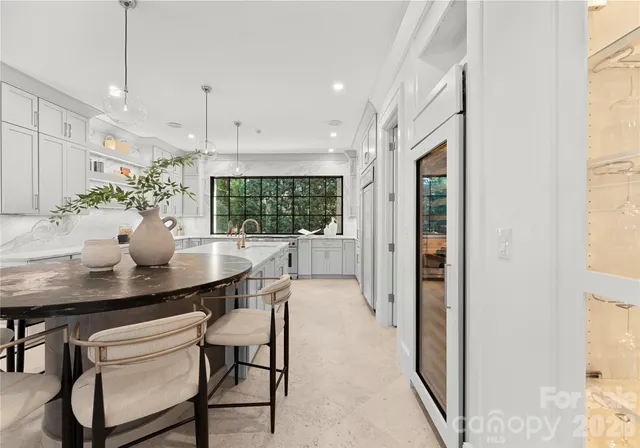 a kitchen that has a lot of cabinets in it and wooden floors