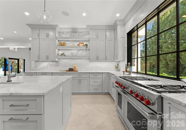 an open kitchen with stainless steel appliances kitchen island granite countertop a large island in the center