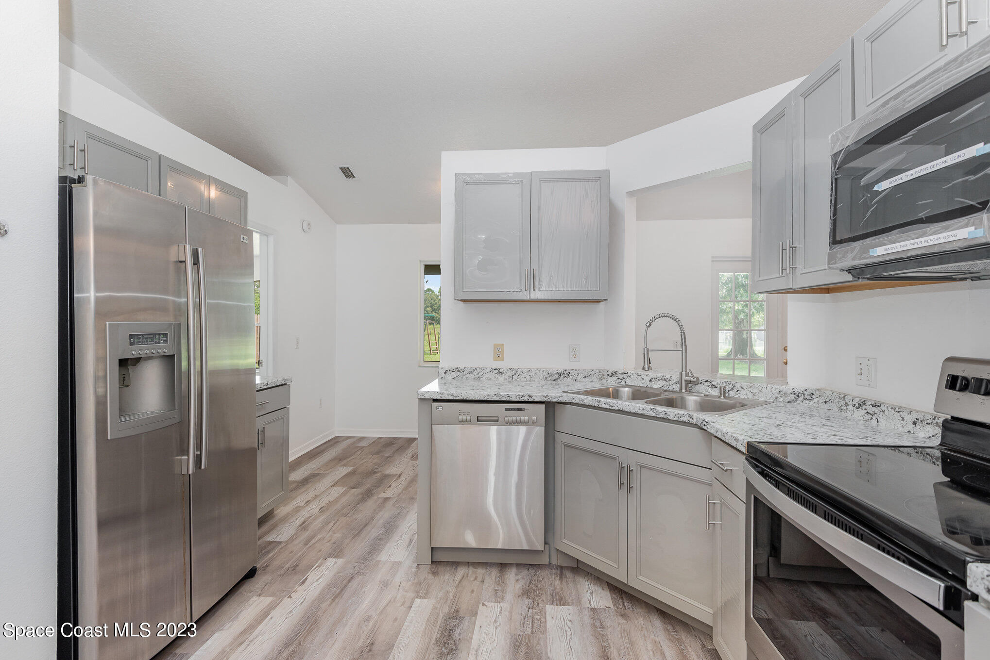 4390 London Town Road Titusville, FL 32796 - Photo 12 of 25 a kitchen with a sink stove and refrigerator