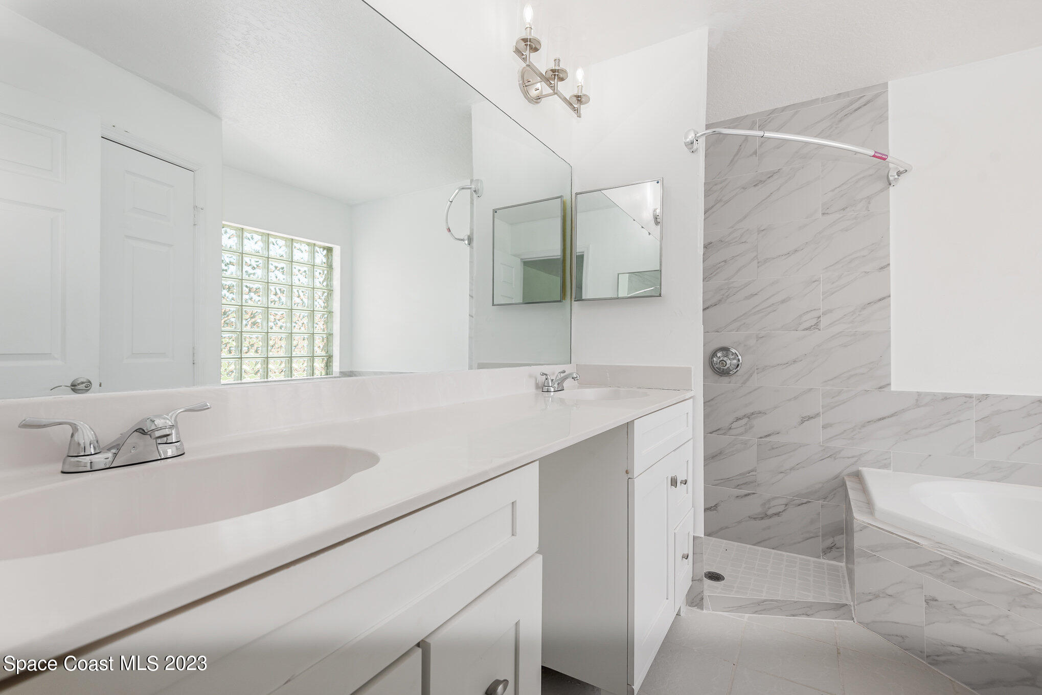 4390 London Town Road Titusville, FL 32796 - Photo 16 of 25 a bathroom with a sink double vanity and a bathtub