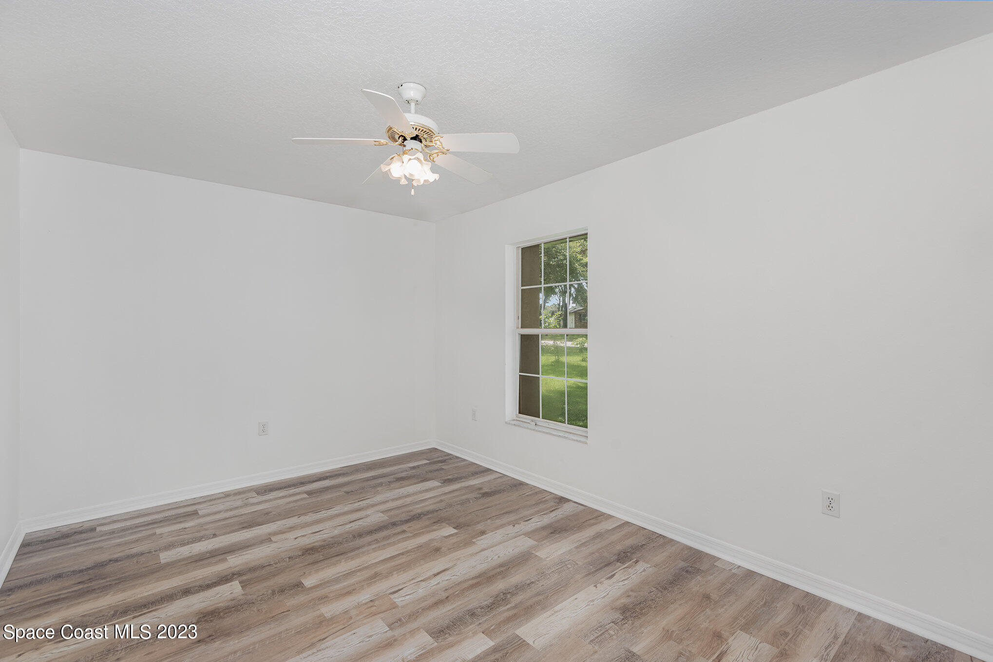 4390 London Town Road Titusville, FL 32796 - Photo 19 of 25 an empty room with a window and ceiling fan