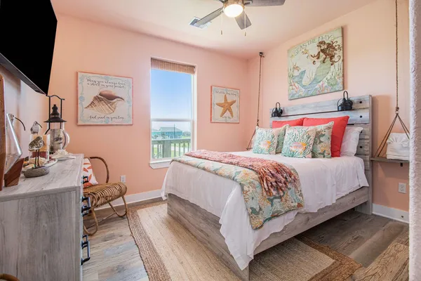 a bedroom with bed and wooden floor