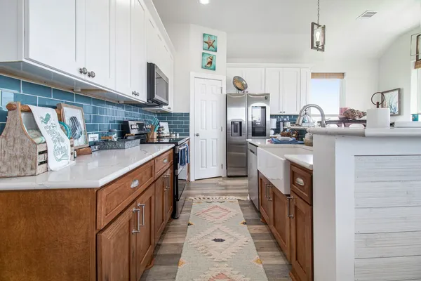 a kitchen with stainless steel appliances granite countertop a sink and a stove