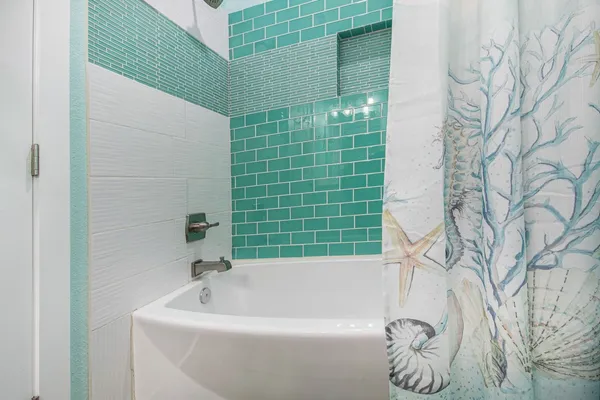 a bathroom with a bathtub and shower