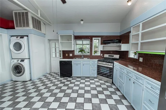 a kitchen with a stove a sink and a cabinets