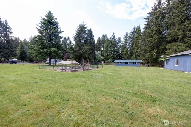 a view of outdoor space with garden and trees