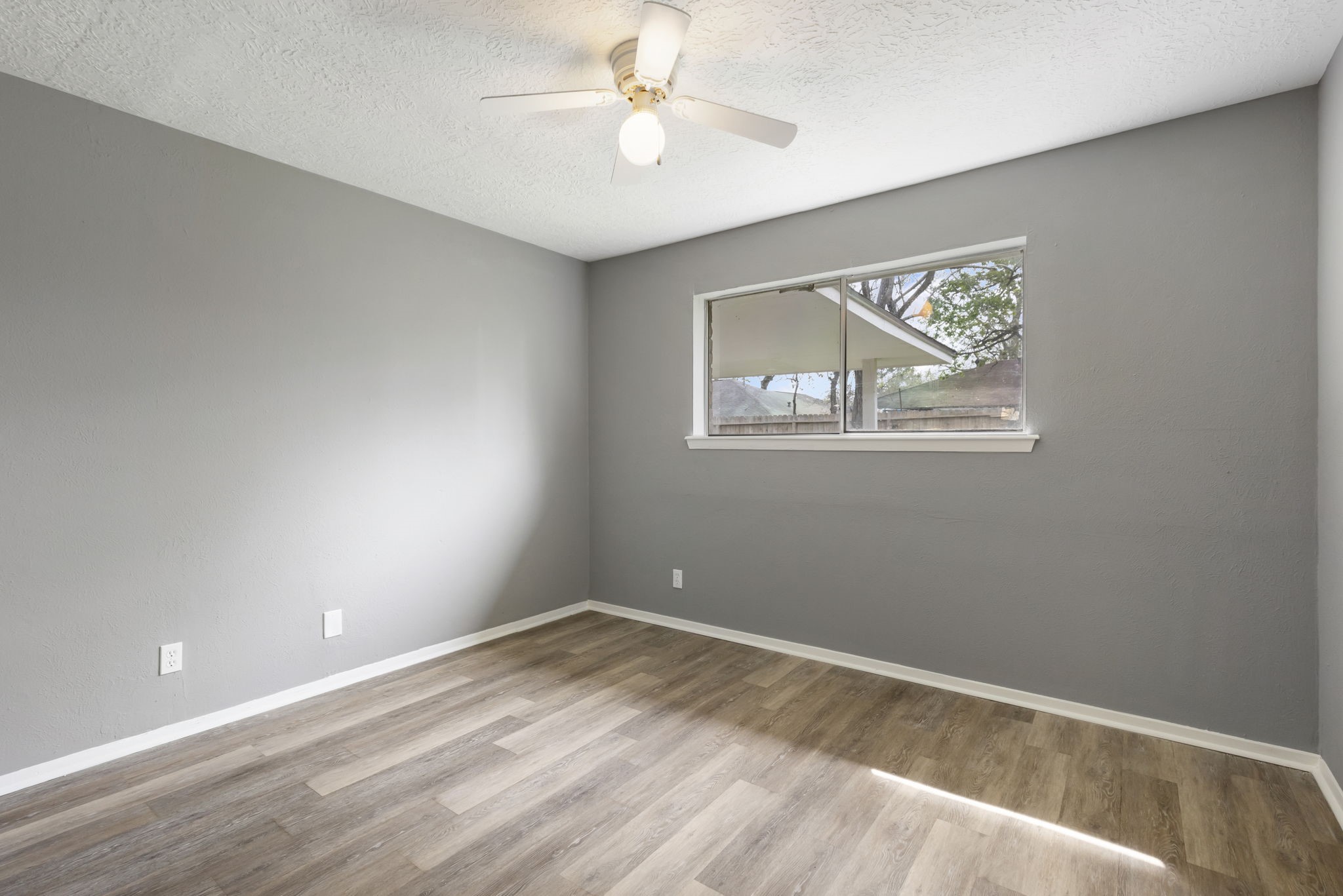 29107 Binefield Street Spring, TX 77386 - Photo 10 of 18 Another secondary bedroom with updated LVP flooring, ceiling fan, and WALK-IN closet.
