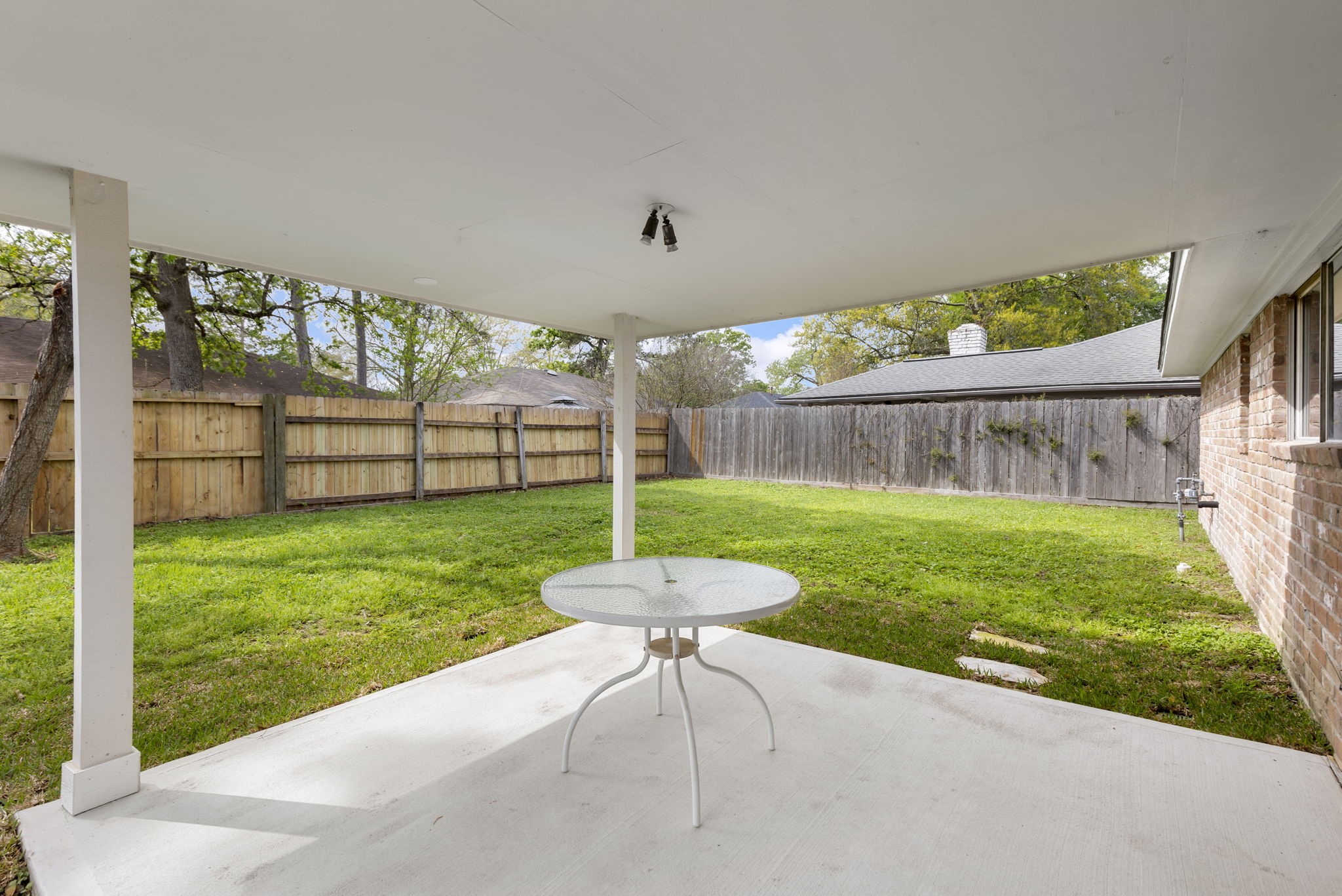 29107 Binefield Street Spring, TX 77386 - Photo 14 of 18 Relax outdoors under the covered patio with reinforced concrete overlay—perfect for morning coffee or evening unwinding!