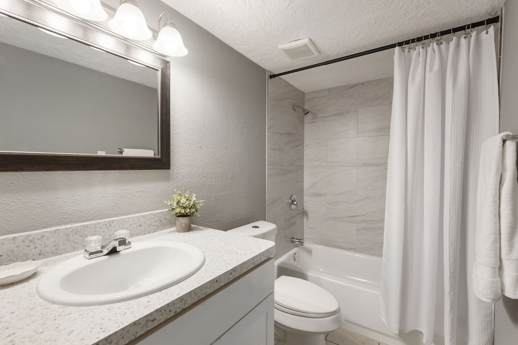 29107 Binefield Street Spring, TX 77386 - Photo 9 of 18 Stylishly remodeled guest bath featuring new vanity, countertop, plumbing fixtures, toilet, decorative mirror, and tub/shower combo with BEAUTIFUL TILE surround.